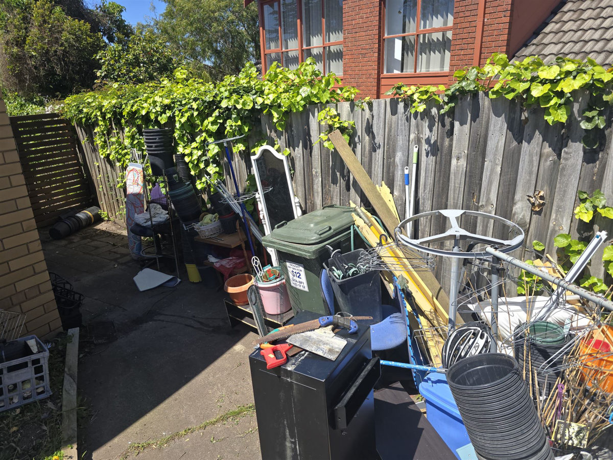 Side yard cluttered with junk