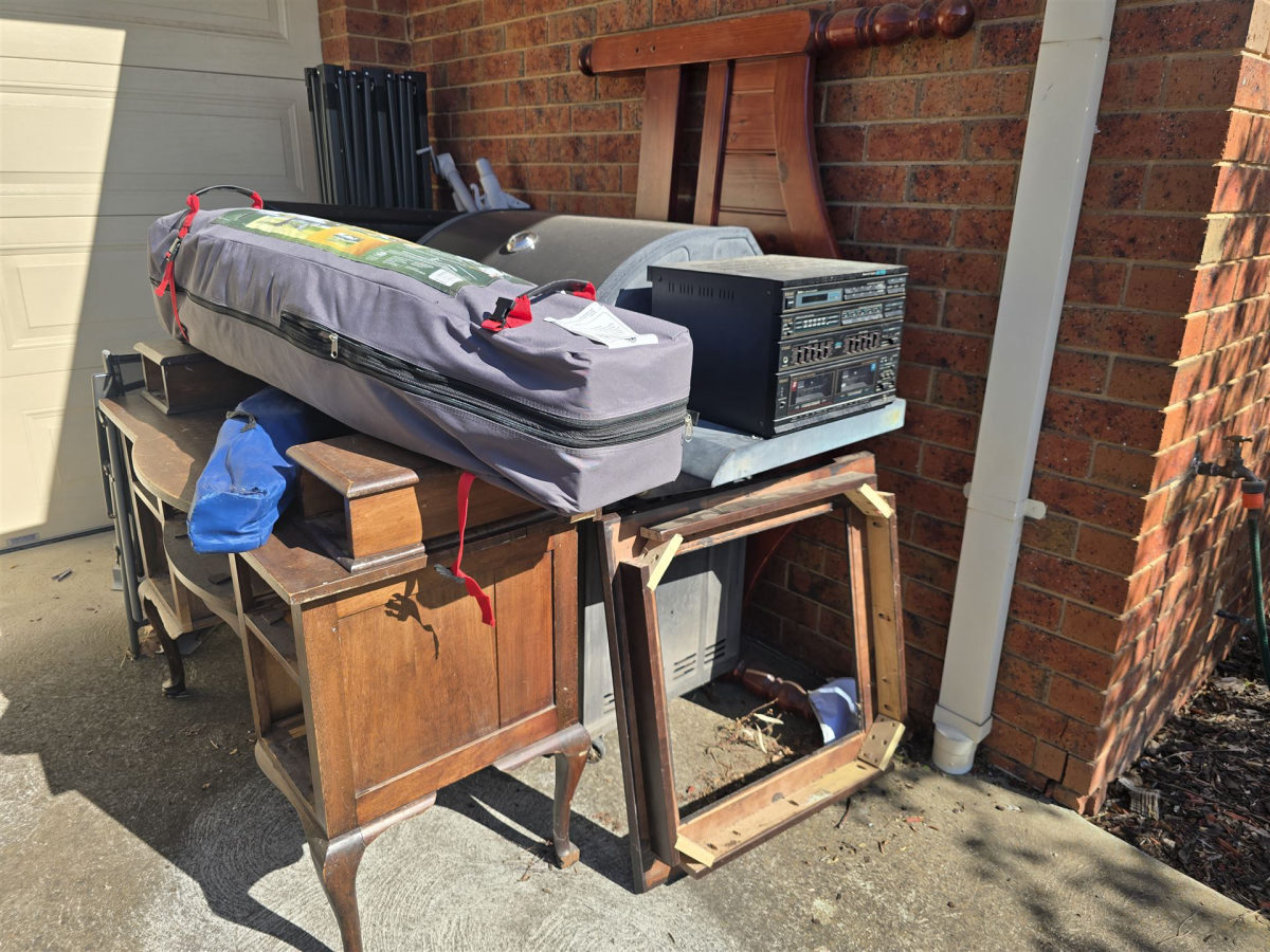 Driveway stacked with old furniture