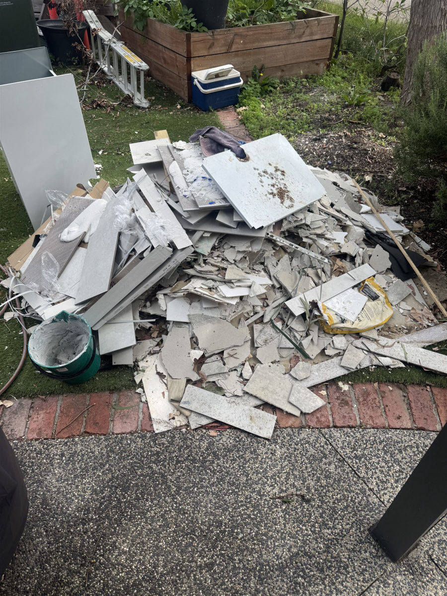 Backyard pile of tiles and plasterboard